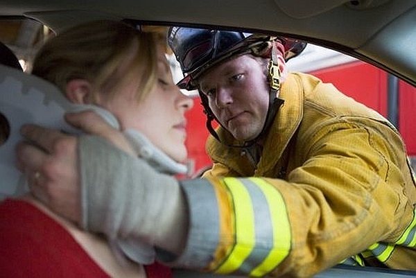 A firefighter helping a car accident victim